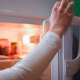 A Hand opens a fridge.