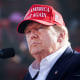 Donald Trump wears a MAGA hat.