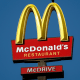 Signs for McDonald's and Wendy's restaurants.