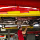An employee installs parts on the undercarriage