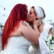 Alba Ahmetaj and Edlira Mara kiss during their wedding ceremony outside