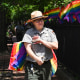 A park ranger places rainbow flags at the Stonewall National Monument