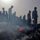 Palestinians gather at the site of an Israeli strike in Rafah