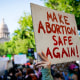 Demonstrators with a sign that reads 'MAKE ABORTION SAFE AGAIN.'