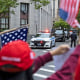 Trump supporters wave flags and cheer as the motorcade carrying former President Donald Trump leaves Manhattan criminal court.
