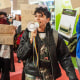 A demonstrator speaks through a megaphone while other protesters hold signs