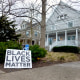 Image: A Black Lives Matter sign sits in front of a home on March 23, 2021 in Evanston, Ill.