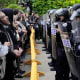 Pro-Palestinian protesters chant at the University of Chicago police while being kept from the university's quad as the student encampment is dismantled on May 7, 2024