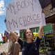 A protester holds a sign that reads, "My Body! My Choice!"