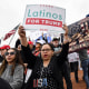 Supporters of Donald Trump hold signs, one saying "Latinos for Trump 2020"