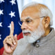Close up of Narendra Modi point a finger up in front of an American flag