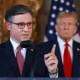 Republican presidential candidate Donald Trump listens as Speaker of the House Mike Johnson speaks during a press conference on April 12, 2024, in Palm Beach, Florida.