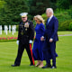 President Joe Biden and first lady Jill Biden walk with Maj. Gen. Robert B. Sofge Jr. as they attend a wreath-laying ceremony