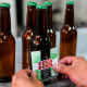 A worker puts a label reading "Coca Beer" on coca leaf-flavored beer bottles