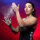 Brooke Raboutou dusts her hands together with chalk powder