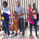 Immigrants from Haiti wait in line to be processed by the U.S. Border Patrol in Yuma, Ariz.