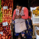 A vendor waits for customers at her produce stand in La Paz, Bolivia
