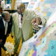 Four people stand around a redistricting map