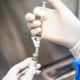 A pharmacist holds a vial of lenacapavir.