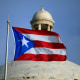 The Puerto Rican flag flies in front of the Capitol in San Juan.