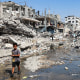 A boy walks among rubble in the Jabalia camp in the northern Gaza Strip on August 14, 2024. 