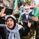 Members of the Palestinian Joint Action Committee carry a casket with a picture of Ismail Haniyeh's face on it