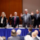 Executives stand as they are sworn -in 