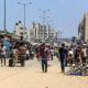 Palestinians, living in makeshift tents, leave to find safer areas as they carry their belongings.