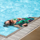 A older woman woman floats in a pool