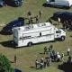 Police and officials on the lawn of a high school campus