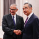 US White House senior adviser and climate envoy John Podesta (L) shakes hands with China's Foreign Minister Wang Yi at the Great Hall of the People in Beijing on September 6, 2024.