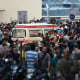 People surround ambulances