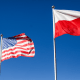 Polish and U.S. national flags fly