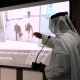 A presenter points to video footage showing two of the 11 suspects involved in the recent killing of a senior Hamas military commander in Dubai