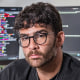 Hasan Piker sits for a portrait at his computer station