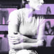 Photo Illustration: A young woman hugging herself against a backdrop of blurred posts from eating disorder accounts on X