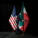 A staff removes the Iranian flag from the stage