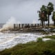 Waves impact a house seawall