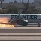 A Frontier flight with flames visible underneath the aircraft at Harry Reid International Airport in Las Vegas.