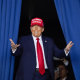 Donald Trump gestures as he arrives to speak