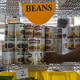 A volunteer restocks canned food on the shelves of a food bank