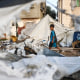 A child walks next to destoyed tents