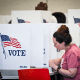 Image: A person votes during early voting at a polling station