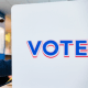 A man votes in a voting booth