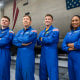 The four crew members that comprise the SpaceX Crew-8 mission pose for a photo inside SpaceX Hangar X at the Kennedy Space Center