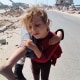 Gaza girl carries injured sister