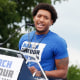 Trevon Bosley speaks onstage behind a podium with a sign that says "March for Our Lives"