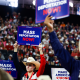 People hold "Mass Deportation Now" signs at the Republican National Convention in Milwaukee, Wisc. on July 17, 2024. 