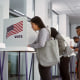 Asian woman voting booths in polling station office