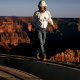 A construction worker walks along a steel structure 